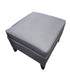 Used dark gray brushed vinyl ottoman with cushioned top and wood legs sourced from an upscale resort