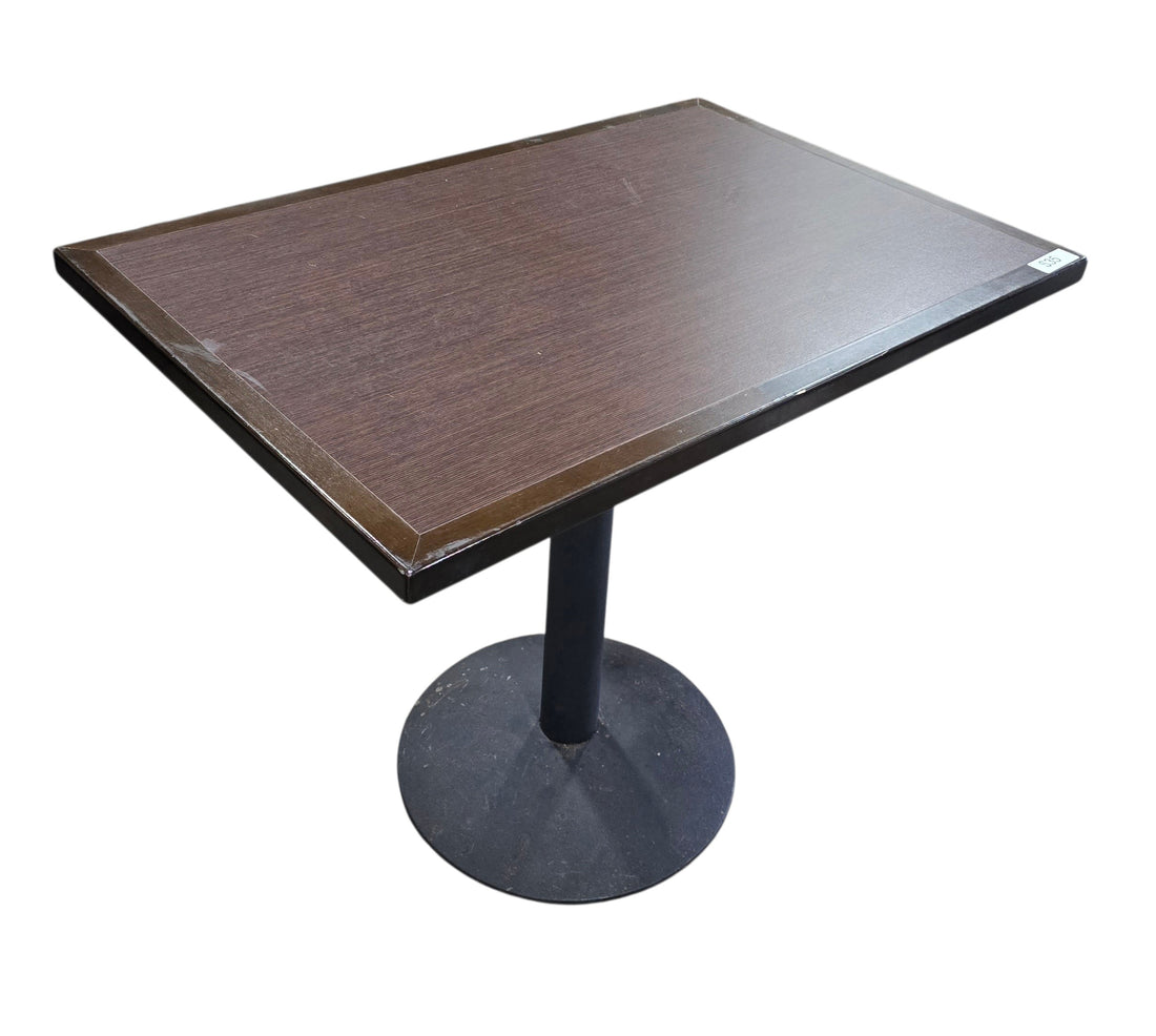 Quality used resort dining table featuring a dark wood rectangular top and black metal pedestal base