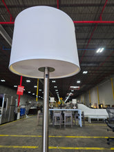 SHL quality used brushed nickel floor lamp showing white drum shade and metal pole sourced from an upscale resort