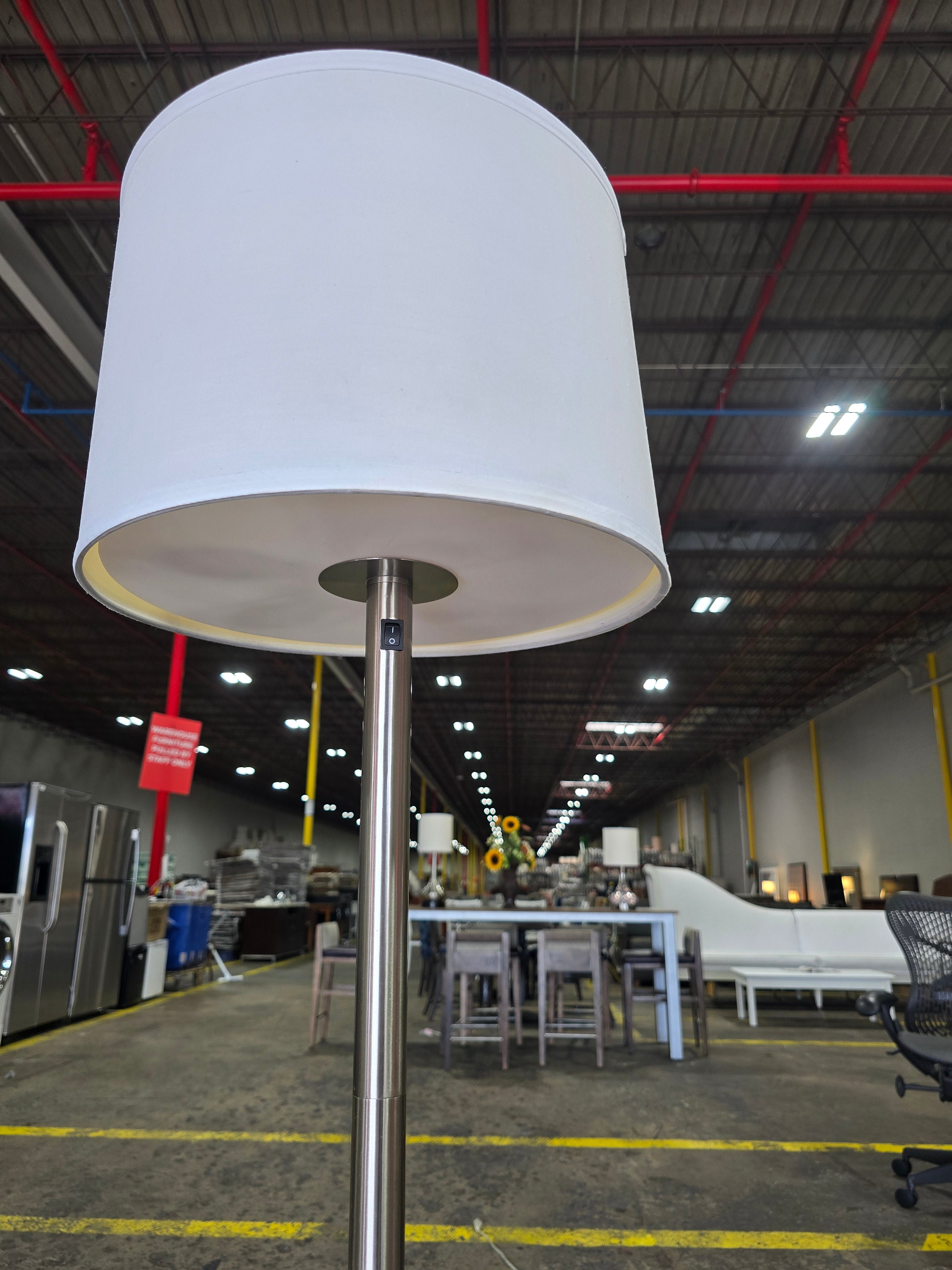 SHL quality used brushed nickel floor lamp showing white drum shade and metal pole sourced from an upscale resort