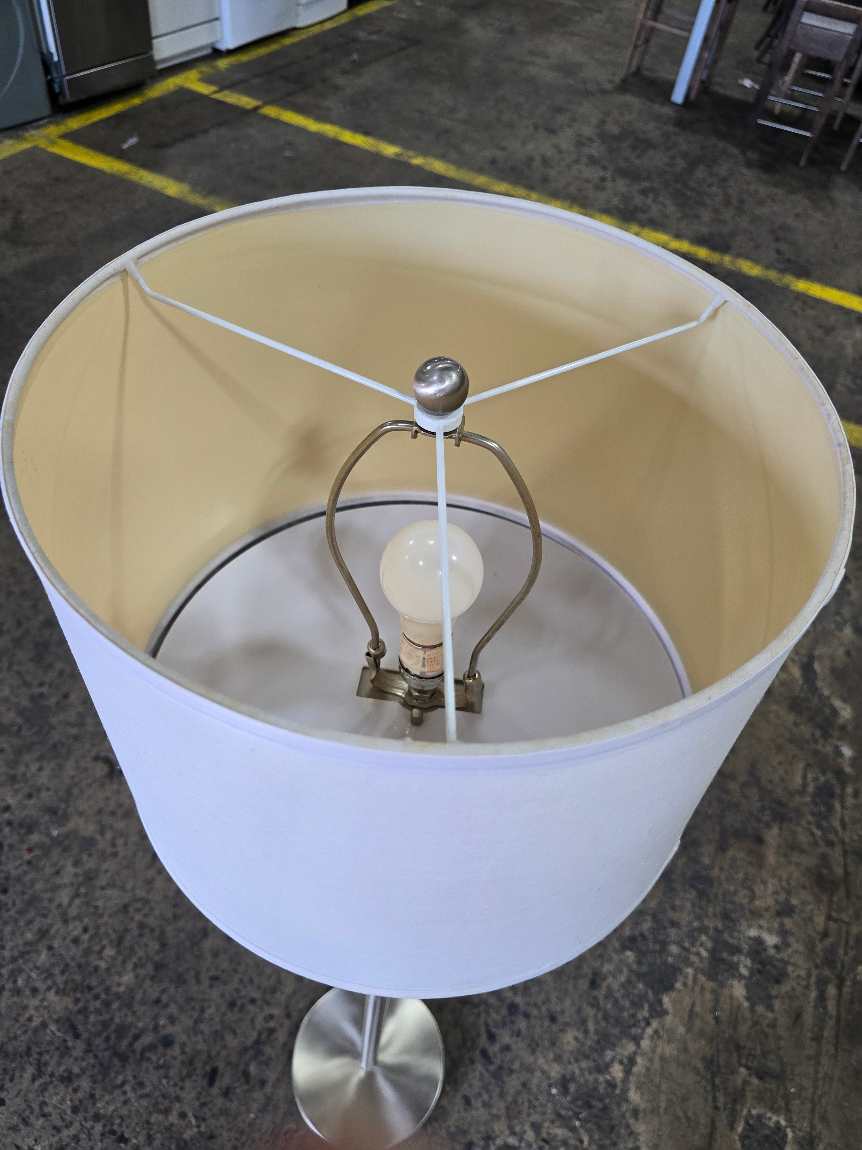 SHL quality used modern floor lamp with white drum shade viewed from above showing socket and harp sourced from an upscale resort