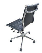 Used modern executive office chair with black faux leather upholstery and chrome frame from upscale resort
