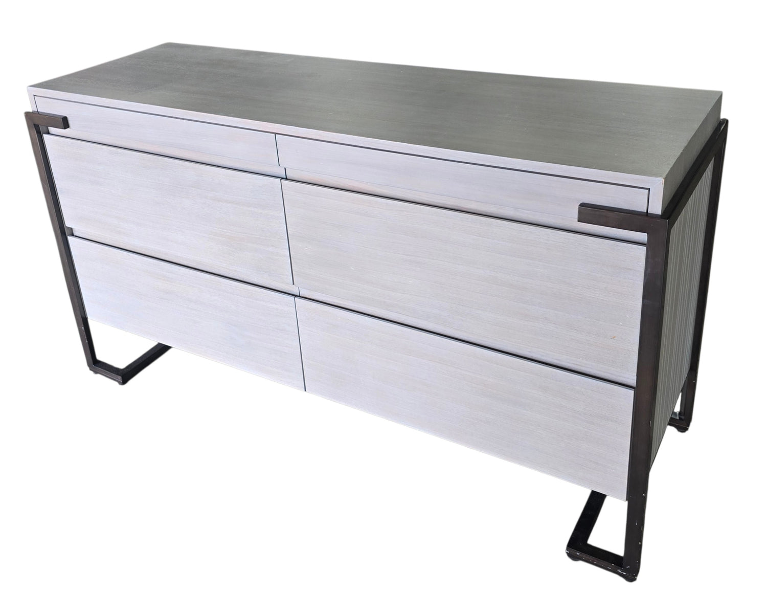 Angled view of a used Montague gray wood 4 drawer dresser with soft close drawers and metal frame from Southern Hospitality Liquidation in Cartersville, GA near Atlanta, Marietta, Kennesaw, and Rome.