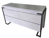 Angled view of a used Montague gray wood 4 drawer dresser with soft close drawers and metal frame from Southern Hospitality Liquidation in Cartersville, GA near Atlanta, Marietta, Kennesaw, and Rome.