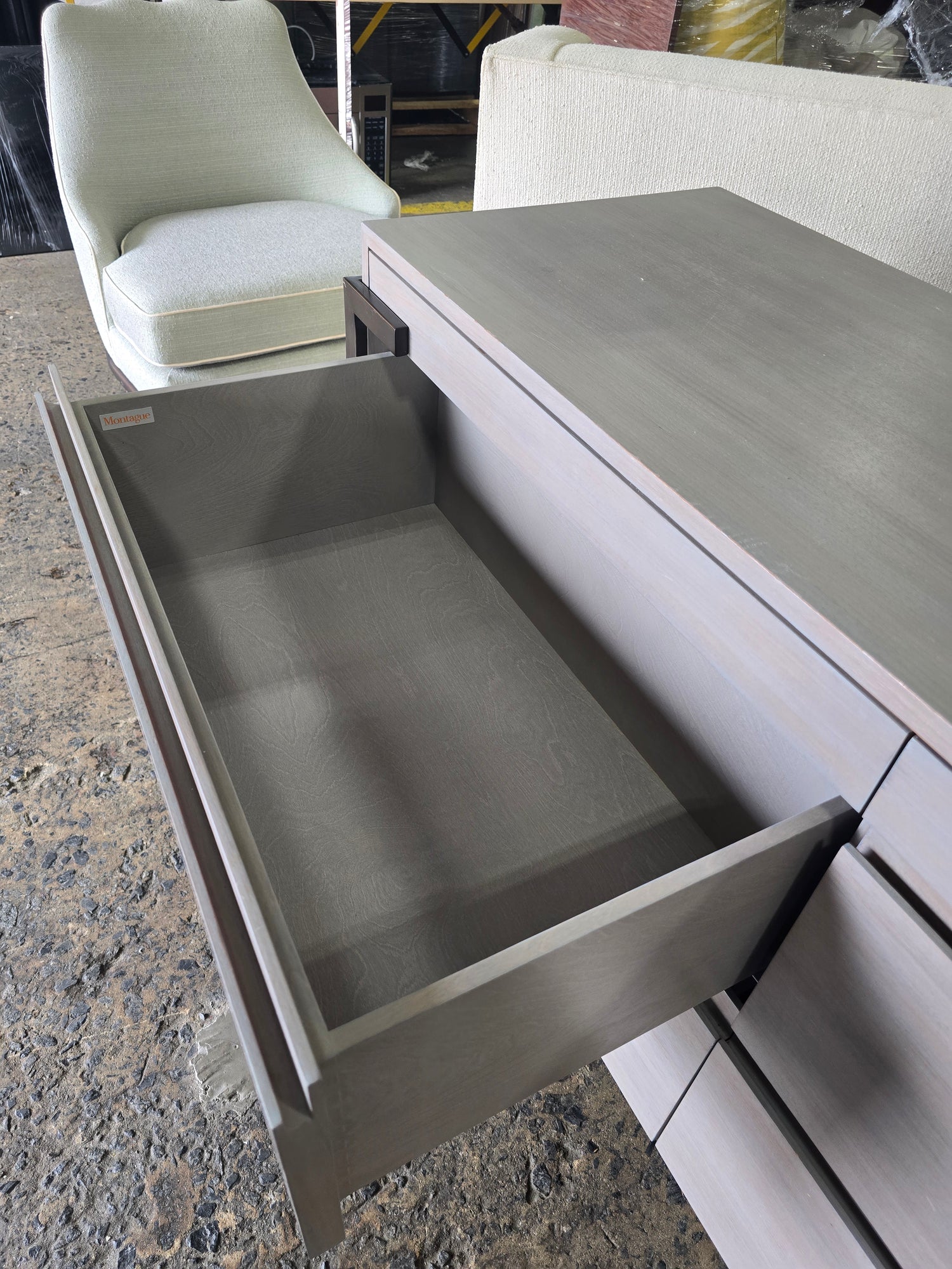 Used Montague 4 drawer gray wood dresser with soft close drawers, showing open drawer detail, sourced from an upscale resort by Southern Hospitality Liquidation in Cartersville, GA near Atlanta, Marietta, Kennesaw, and Rome.