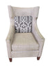 SHL used neutral beige wingback accent chair with gray geometric accent pillow sourced from upscale resort