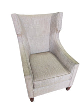 SHL used neutral beige wingback accent chair sourced from upscale resort with textured fabric upholstery and wood legs