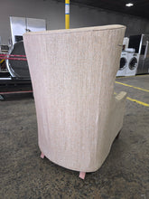 SHL used neutral beige wingback accent chair rear view displaying textured upholstery and tapered wood legs