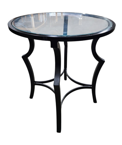 SHL used round glass top accent table with decorative black metal base sourced from an upscale resort
