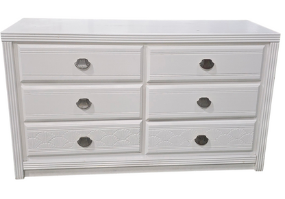 Front view of white dresser with shell shaped drawer pulls