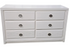 Front view of white dresser with shell shaped drawer pulls