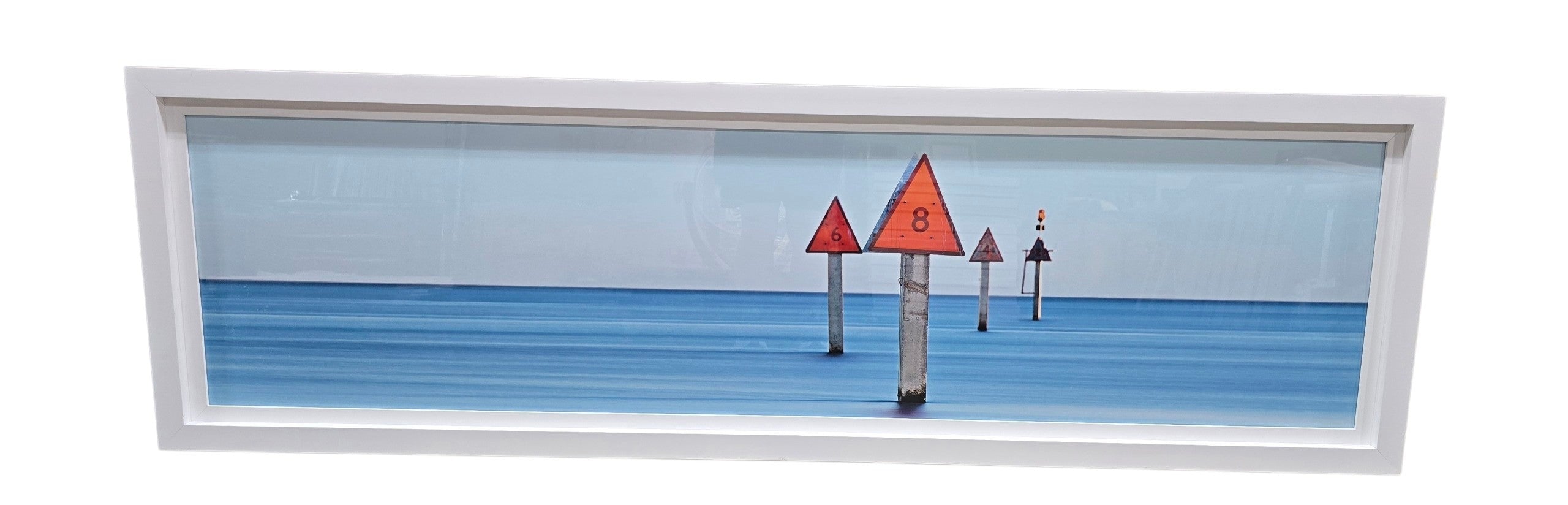 HL panoramic coastal channel marker wall art featuring red navigational markers in calm blue ocean water with white frame measuring 81.5 x 24.5 used in good condition