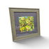 Framed tropical botanical photograph showing green foliage and colorful berry clusters with weathered gray frame