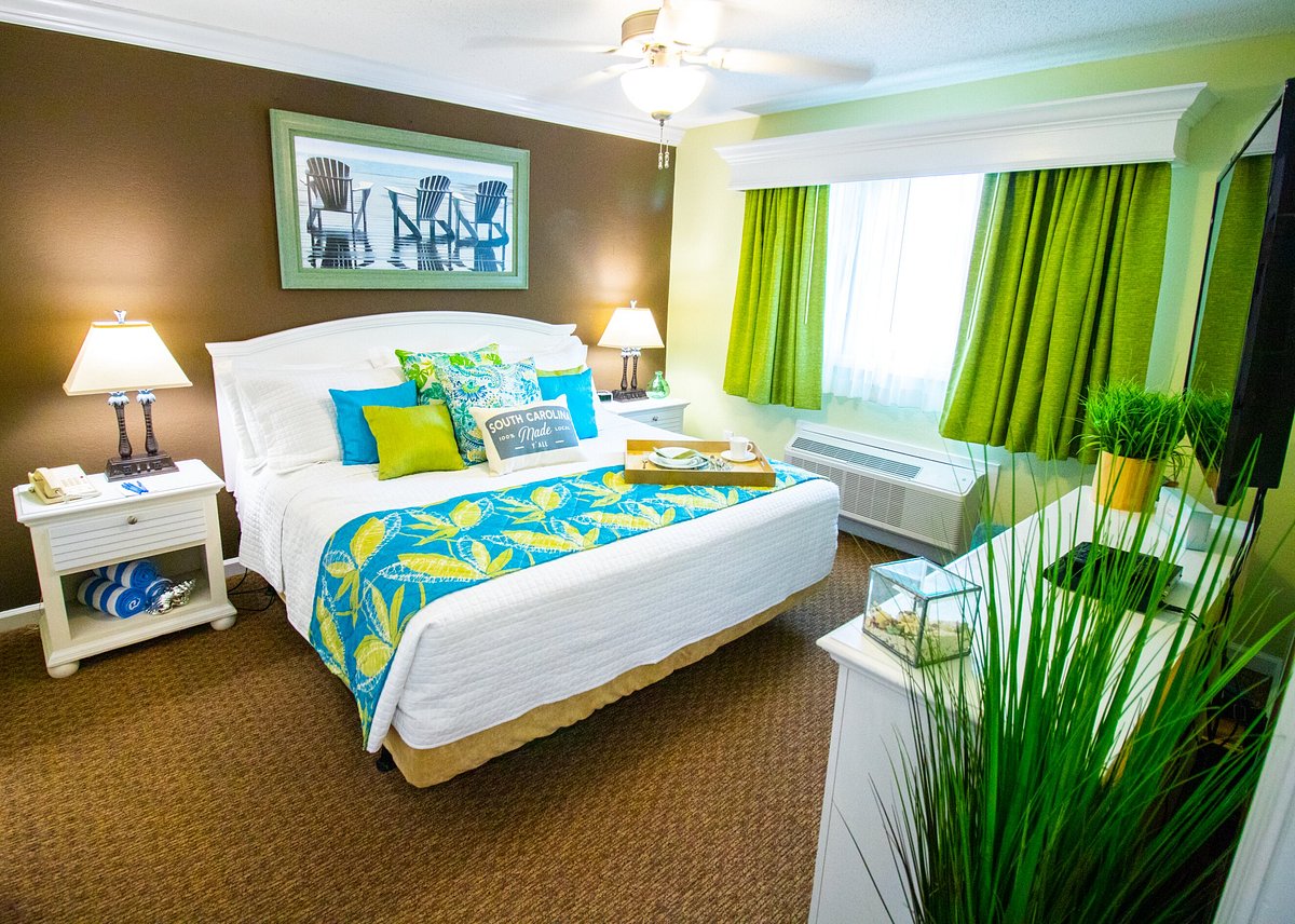 Used Grand Palms king room furniture package – mattress, headboard, TV dresser, nightstands, lamps, accent chair, and art