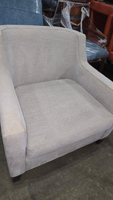 Gray accent chair in club design with arms, versatile seating for homes, rentals, and hotels