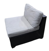 Angled view of outdoor woven black seat with removable cushions, showing woven texture and sturdy frame.