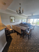 Reunion Resort dining room package includes 8-top dining table, chairs, sideboard, bar stools and artwork