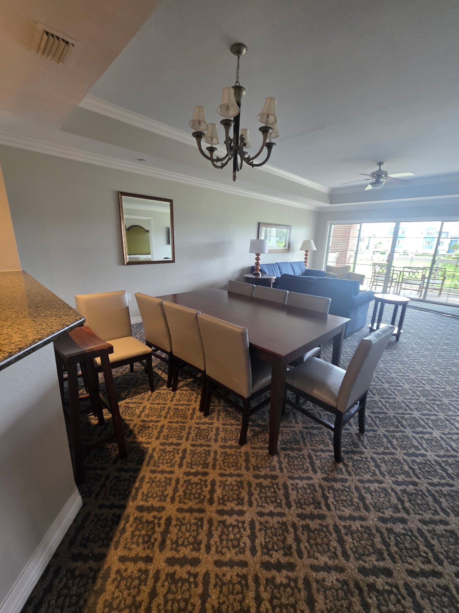 Reunion Resort dining room package includes 8-top dining table, chairs, sideboard, bar stools and artwork