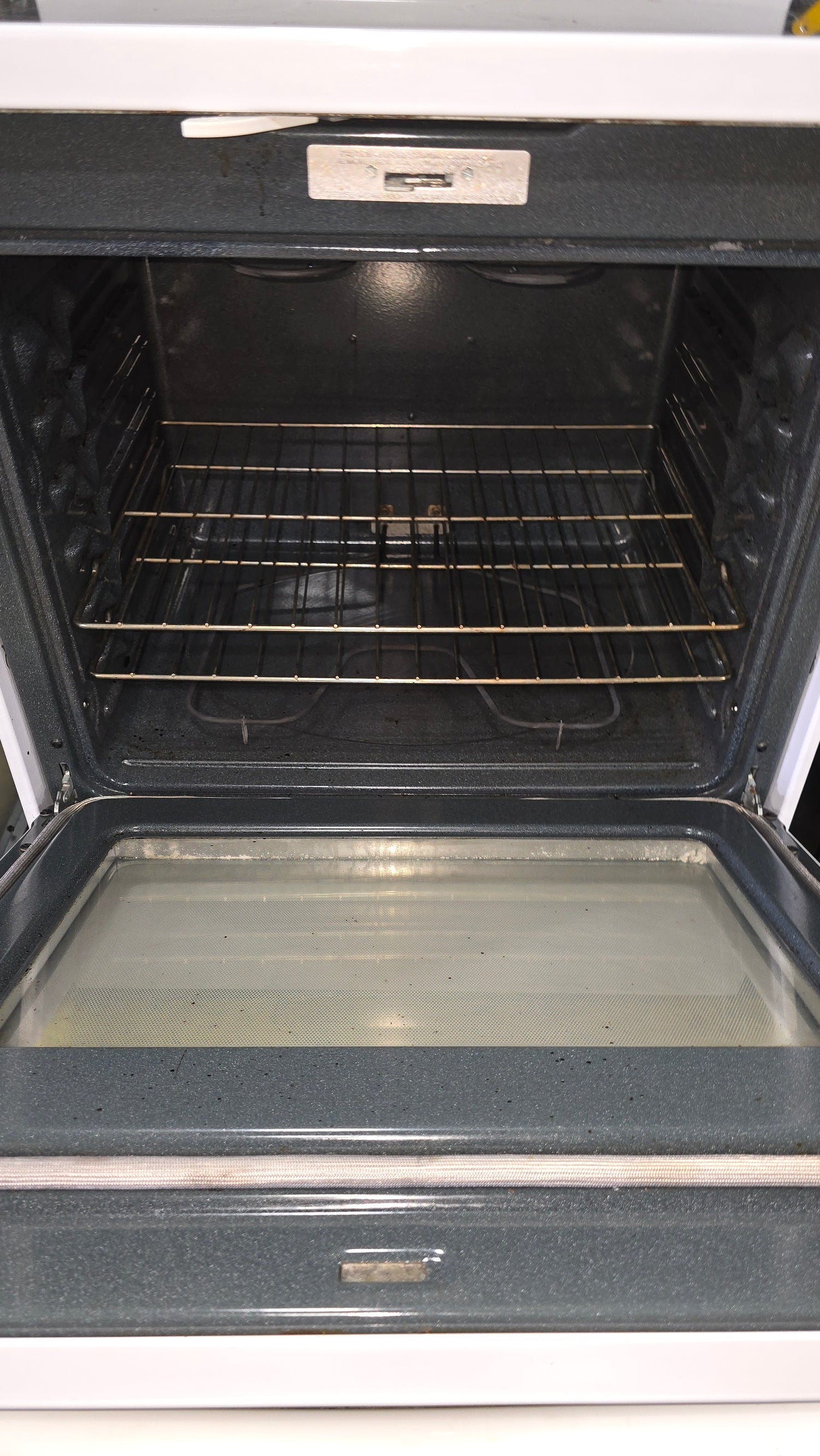 Interior oven view of GE 30-inch glass top stove showing racks and spacious design from SHL