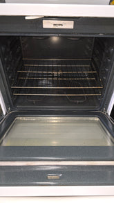 Interior oven view of GE 30-inch glass top stove showing racks and spacious design from SHL
