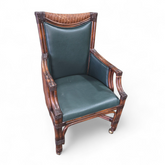 SHL rattan rolling chair with dark green vinyl seat and back, used and in good condition, upscale resort furniture