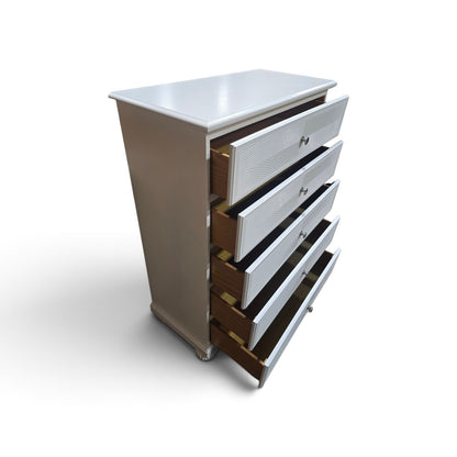 Used white five-drawer chest with decorative wave-pattern fronts and open drawers, SHL.