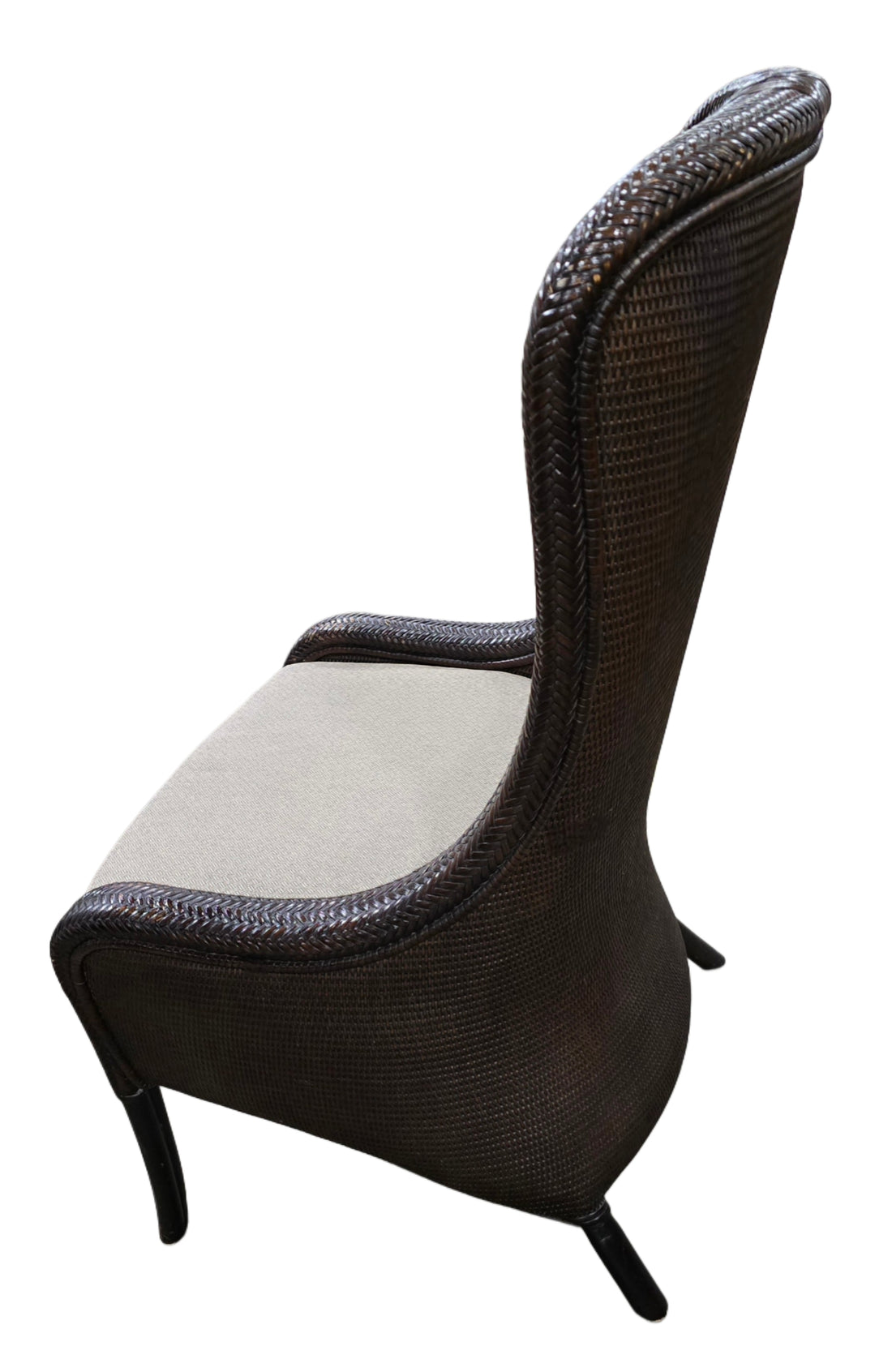 Side view of Tommy Bahama wicker chair showing beige seat and woven frame