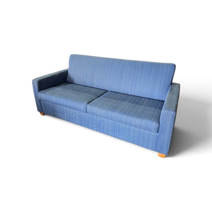Used blue upholstered queen sleeper sofa shown at an angle with track arms and wood-finish feet, SHL