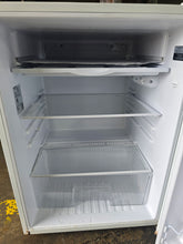 Used SHL GE compact refrigerator interior with glass shelves and crisper