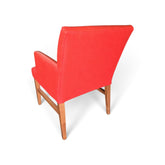 Back view of used red vinyl upholstered dining chair showing solid red backrest and brown wood-finish frame, SHL