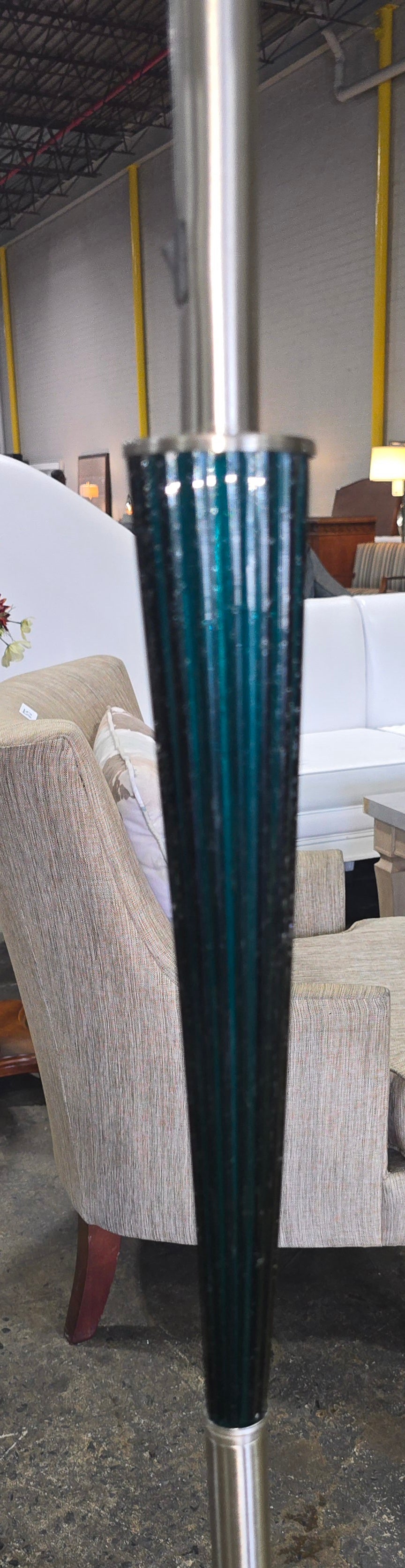Close-up of the blue ribbed glass accent on a used floor lamp sourced from an upscale resort and available at Southern Hospitality Liquidation.