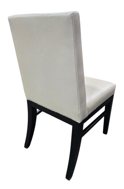 Rear view of used commercial upholstered dining chair with black wood frame, sourced from an upscale resort and available at Southern Hospitality Liquidation.