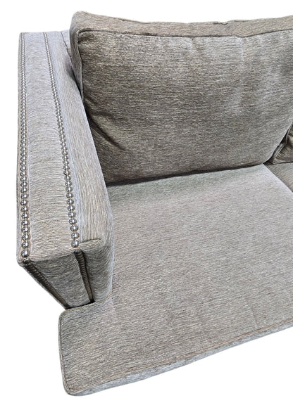 Close-up of nailhead trim and upholstery on used sleeper sofa