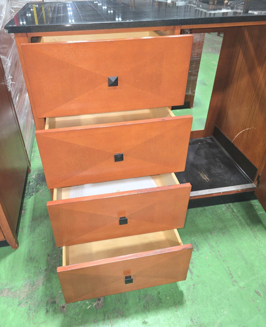 Open drawers on a used Kimball Hospitality 6 drawer dresser with black granite top from Southern Hospitality Liquidation
