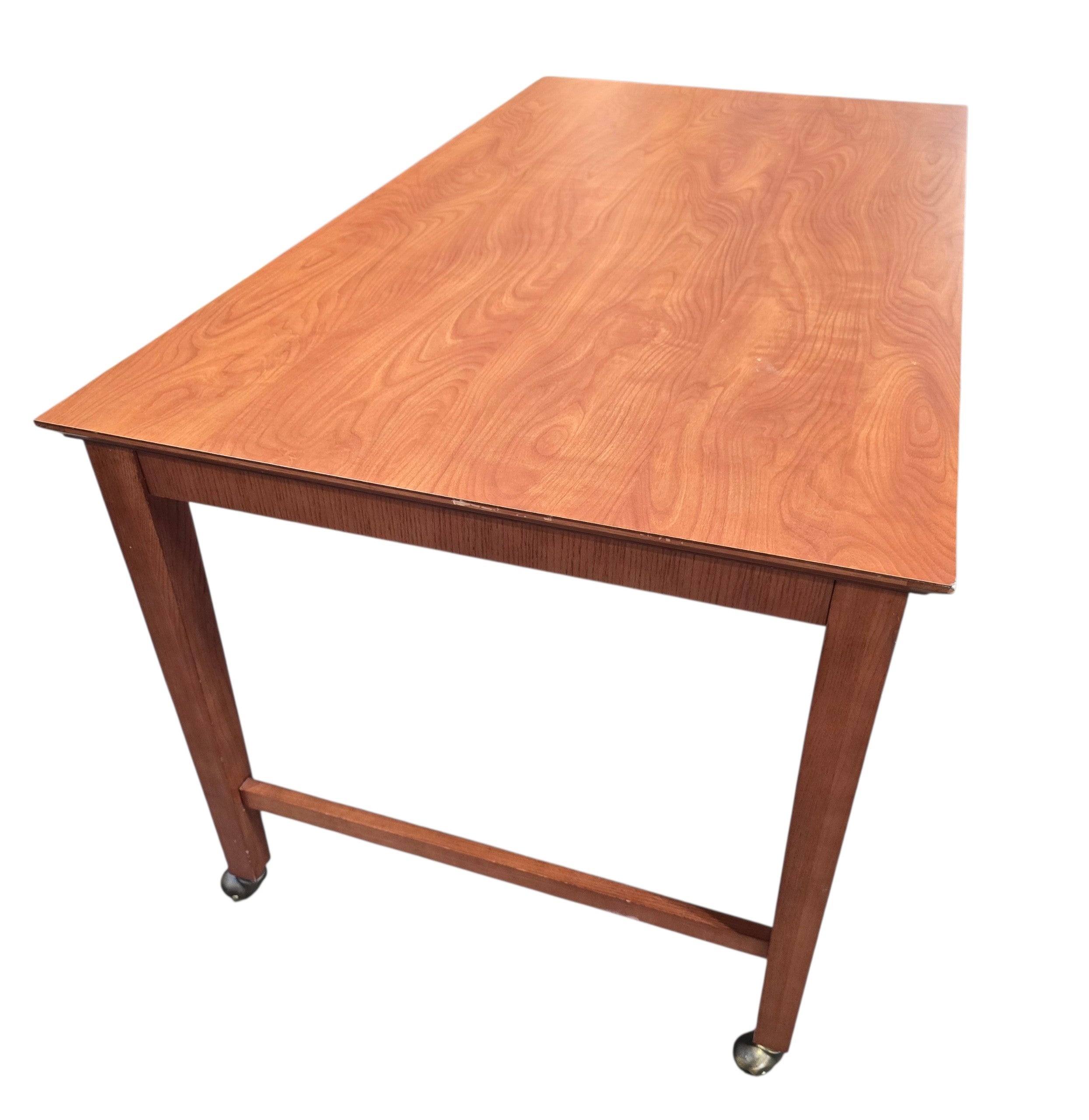 Used rolling wood writing desk with spacious work surface and brass casters, angled view, at Southern Hospitality Liquidation in Cartersville, GA.