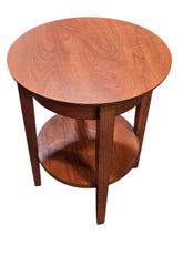 Used round wood end table with lower storage shelf, angled view, at Southern Hospitality Liquidation in Cartersville, GA.