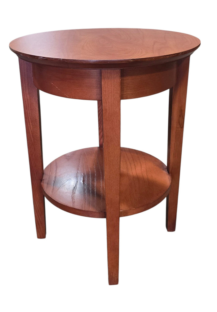 Used round wood end table with lower shelf, front view, at Southern Hospitality Liquidation in Cartersville, GA.
