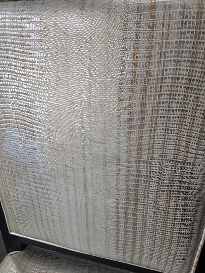 Close-up of the shiny embossed vinyl upholstery on a used dining chair from Southern Hospitality Liquidation.