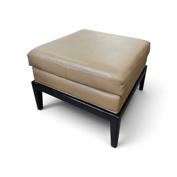 Used tan vinyl ottoman with black wood base, front view from Southern Hospitality Liquidation.