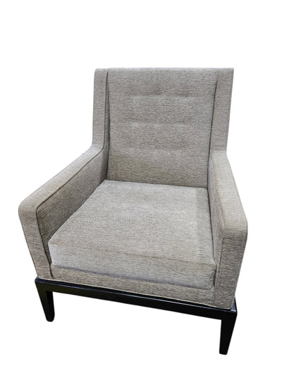 Used upholstered lounge accent chair with textured neutral fabric and black wood base, front view, at Southern Hospitality Liquidation.